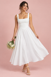 Robe midi blanche à fines bretelles et ourlet ample | Vue de face | Lounelle Paris
